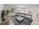 Stylish living room with a large sectional sofa, marble coffee table, and modern decor at 12710 Es Draper Dr, Huntersville, NC 28078