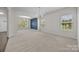Spacious living room with neutral carpet, abundant natural light, and an open layout at 12710 Es Draper Dr, Huntersville, NC 28078