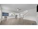 Open-concept living space with hardwood floors, white cabinets, and a modern kitchen island at 12710 Es Draper Dr, Huntersville, NC 28078