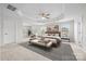 Luxurious main bedroom with tray ceilings, a ceiling fan, and ample natural light at 12710 Es Draper Dr, Huntersville, NC 28078