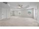 Large main bedroom featuring tray ceiling, windows and neutral carpet at 12710 Es Draper Dr, Huntersville, NC 28078