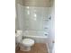Clean bathroom with a new tub, toilet, and vinyl floors at 132 Loomis St, Chester, SC 29706