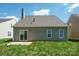 Exterior view of the back of the house showing the siding, windows, roof, and grass backyard at 1409 Rheo Nw Ct, Concord, NC 28027