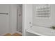 This bright bathroom features a separate shower and bathtub, and a frosted window at 1409 Rheo Nw Ct, Concord, NC 28027