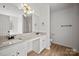 Bright bathroom features double sinks with granite counters, modern lighting, and walk-in shower at 1409 Rheo Nw Ct, Concord, NC 28027