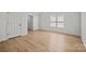 This bedroom features wood-look flooring, a window, and double door closet at 1409 Rheo Nw Ct, Concord, NC 28027