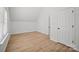 This bedroom features a large window with natural light and wood-look floors at 1409 Rheo Nw Ct, Concord, NC 28027