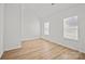 This bedroom features hardwood floors and two windows at 1409 Rheo Nw Ct, Concord, NC 28027