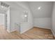 Spacious bonus room featuring wood-look floors and access to another room via small staircase at 1409 Rheo Nw Ct, Concord, NC 28027