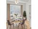 Cozy breakfast nook with a round table, seating for four, and lots of natural light at 1409 Rheo Nw Ct, Concord, NC 28027