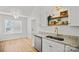 Eat-in kitchen area features a stylish light fixture, open shelving, and natural light at 1409 Rheo Nw Ct, Concord, NC 28027