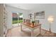 Bright home office with a desk, shelving, and a sliding glass door to the backyard at 1409 Rheo Nw Ct, Concord, NC 28027