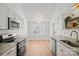Bright, updated kitchen features granite countertops, stainless appliances, and eat-in dining area at 1409 Rheo Nw Ct, Concord, NC 28027