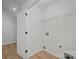 Functional laundry room with wire shelving, electrical and plumbing hookups, and wood-look floors at 1409 Rheo Nw Ct, Concord, NC 28027
