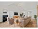 Bright living room with high ceilings, fireplace, and stylish furnishings at 1409 Rheo Nw Ct, Concord, NC 28027