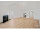 Bright living room boasts hardwood floors, fireplace, and vaulted ceiling at 1409 Rheo Nw Ct, Concord, NC 28027
