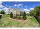 Landscaped backyard with black fence, trees, bushes and a view of the home's exterior at 1497 Tranquility Blvd # 417, Lancaster, SC 29720