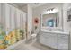 Clean bathroom featuring a vanity with drawers, a framed mirror, and a shower with a floral curtain at 1497 Tranquility Blvd # 417, Lancaster, SC 29720