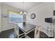 Cozy dining room features hardwood floors, modern chandelier, and window with blinds at 1497 Tranquility Blvd # 417, Lancaster, SC 29720