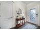 Elegant foyer with a decorative mirror, stylish table, and hardwood floors, creating a warm welcome at 1497 Tranquility Blvd # 417, Lancaster, SC 29720