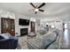 Open-concept living room with fireplace, ceiling fan, and view into bright, modern kitchen at 1497 Tranquility Blvd # 417, Lancaster, SC 29720