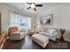 Cozy living room featuring hardwood floors, neutral furniture, and a bright window with natural light at 1497 Tranquility Blvd # 417, Lancaster, SC 29720