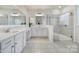 Bright main bathroom with double vanity, large mirrors, and tiled walk-in shower at 1497 Tranquility Blvd # 417, Lancaster, SC 29720