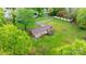 Expansive backyard featuring mature trees surrounding brick house with deck and blue garage door at 1500 19Th Avenue Ne Pl, Hickory, NC 28601