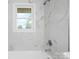 A white tiled bathroom featuring modern fixtures and finishes at 1500 19Th Avenue Ne Pl, Hickory, NC 28601