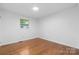A bedroom with hardwood floors, neutral walls, and a window at 1500 19Th Avenue Ne Pl, Hickory, NC 28601