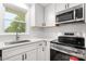 Modern kitchen featuring stainless steel appliances, white cabinets, and sleek countertops at 1500 19Th Avenue Ne Pl, Hickory, NC 28601
