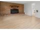 A living room featuring a brick fireplace, hardwood floors, and modern lighting fixtures throughout at 1500 19Th Avenue Ne Pl, Hickory, NC 28601