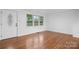 Bright living room featuring hardwood floors, a large window, and a white front door at 1500 19Th Avenue Ne Pl, Hickory, NC 28601