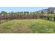 Well-maintained backyard with lush green grass and a black metal fence for added privacy at 15116 Caspian Way, Charlotte, NC 28278