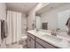 Well-lit bathroom with a double sink vanity, tiled floors, shower-tub combination, and modern fixtures at 15116 Caspian Way, Charlotte, NC 28278