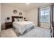 Comfortable bedroom featuring soft carpet, natural light, and stylish bedside tables and shelves at 15116 Caspian Way, Charlotte, NC 28278