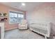 Charming Bedroom with a crib, glider, and soft pink accents creating a serene and comforting environment at 15116 Caspian Way, Charlotte, NC 28278