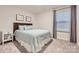Comfortable bedroom featuring a full bed, window with blinds, and warm lighting, ideal for relaxation at 15116 Caspian Way, Charlotte, NC 28278