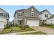 Charming gray two-story home with a two-car garage and well-manicured front yard at 15116 Caspian Way, Charlotte, NC 28278