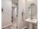 Elegant half bathroom featuring a pedestal sink, oval mirror, and neutral color scheme at 15116 Caspian Way, Charlotte, NC 28278