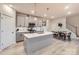 Modern kitchen with gray cabinets, stainless steel appliances, and a central island with pendant lighting at 15116 Caspian Way, Charlotte, NC 28278
