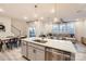 Open-concept kitchen featuring stainless steel appliances, island, and seamless flow to the dining and living areas at 15116 Caspian Way, Charlotte, NC 28278