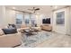 Bright living room with a large sectional sofa, stylish rug, and plenty of natural light at 15116 Caspian Way, Charlotte, NC 28278