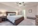 Spacious primary bedroom features a wooden bed frame, bedside lamps, and neutral tones at 15116 Caspian Way, Charlotte, NC 28278