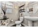 Stylish powder room featuring a pedestal sink and decorative shelving at 152 Blossom Ridge Dr, Mooresville, NC 28117