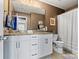 Bathroom with double sink vanity, granite counters, white cabinets, and shower-tub combo at 152 Blossom Ridge Dr, Mooresville, NC 28117