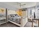 Comfortable bedroom with a white bed frame, patterned bedding, and a ceiling fan at 152 Blossom Ridge Dr, Mooresville, NC 28117