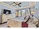 Airy primary bedroom with a ceiling fan, large windows, and light-colored walls at 152 Blossom Ridge Dr, Mooresville, NC 28117