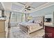 Comfortable bedroom featuring a decorative rug, coffered ceiling, a tufted headboard, and plenty of natural light at 152 Blossom Ridge Dr, Mooresville, NC 28117