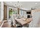 Elegant dining room with stylish chandelier, comfortable seating for six, and backyard views at 152 Blossom Ridge Dr, Mooresville, NC 28117